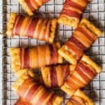Recipe for club crackers wrapped in bacon are a simple idea that can’t be beat. Any bacon wrapped appetizers will be a hit on game day or holidays, so these are a true winner. These tasty bacon crackers won’t disappoint! Ingredients Scale 1x 2x 3x 1 sleeve or more Club Crackers I used Multi-Grain 1 lb. Pepper Bacon thin sliced is best1 lb. Pepper Bacon thin sliced is best 1 c Dark Brown Sugar my personal favorite1 c Dark Brown Sugar my personal favorite 1 c Parmesan Cheese grated other grated cheese would be good, too1 c Parmesan Cheese grated other grated cheese would be good, too Instructions Preheat the oven at 250 degrees. Cover a cookie sheet with aluminum foil. Place a cooling rack above and spray cooking on the rack. Cut the bacon in half. Crackers should be laid flat in rows on cooling racks. Put 1 teaspoon cheese and/or brown sugar on each cracker. Wrap 1/2 slices of bacon around the cracker covered with everything or sugar. (Keep in mind that cheese or sugar does not fall Found.) (If you are using a thick chopped bacon like me, to keep it together, stick a toothpick through the bacon on the top of the cracker. If using a thin bacon, I don’t think it would be necessary. I liked the paper-flavored bacon and I did not get the thin chopped paper. Bacon-ripped crackers on the rack above the cookie Sheet keep Keep the cookie sheet in the oven with crackers. Bake for 2 hours at 250 degrees. If necessary, brief the crackers for only 1-2 minutes to end the bacon crisp and caramelies. Look closely or the sugar will burn quickly. Remove from the oven and cool enough to eat. Enjoy !! Notes These crackers freeze very well. Cool completely, then place it in a freezer bag. When ready to eat, remove from the freezer and let it melt in the bag itself. Preheat the oven at 250 degrees and bake for 15-20 minutes or until the bacon is hot and sizzling.