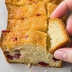 This glazed lemon and cranberry bread is the perfect quick sweet bread recipe for the holidays. Finished with a sweet and tangy lemon glaze, this bread loaf is perfect for Christmas breakfasts and brunch and wonderful as a mid afternoon snack with a cup of coffee.