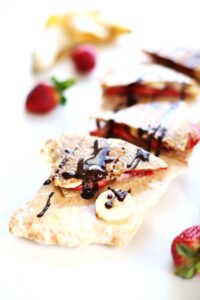 This strawberry banana breakfast quesadilla is your favorite childhood sandwich totally remixed quesadilla style. Whether you have it for breakfast, lunch or dessert your childhood cravings will totally thank you.